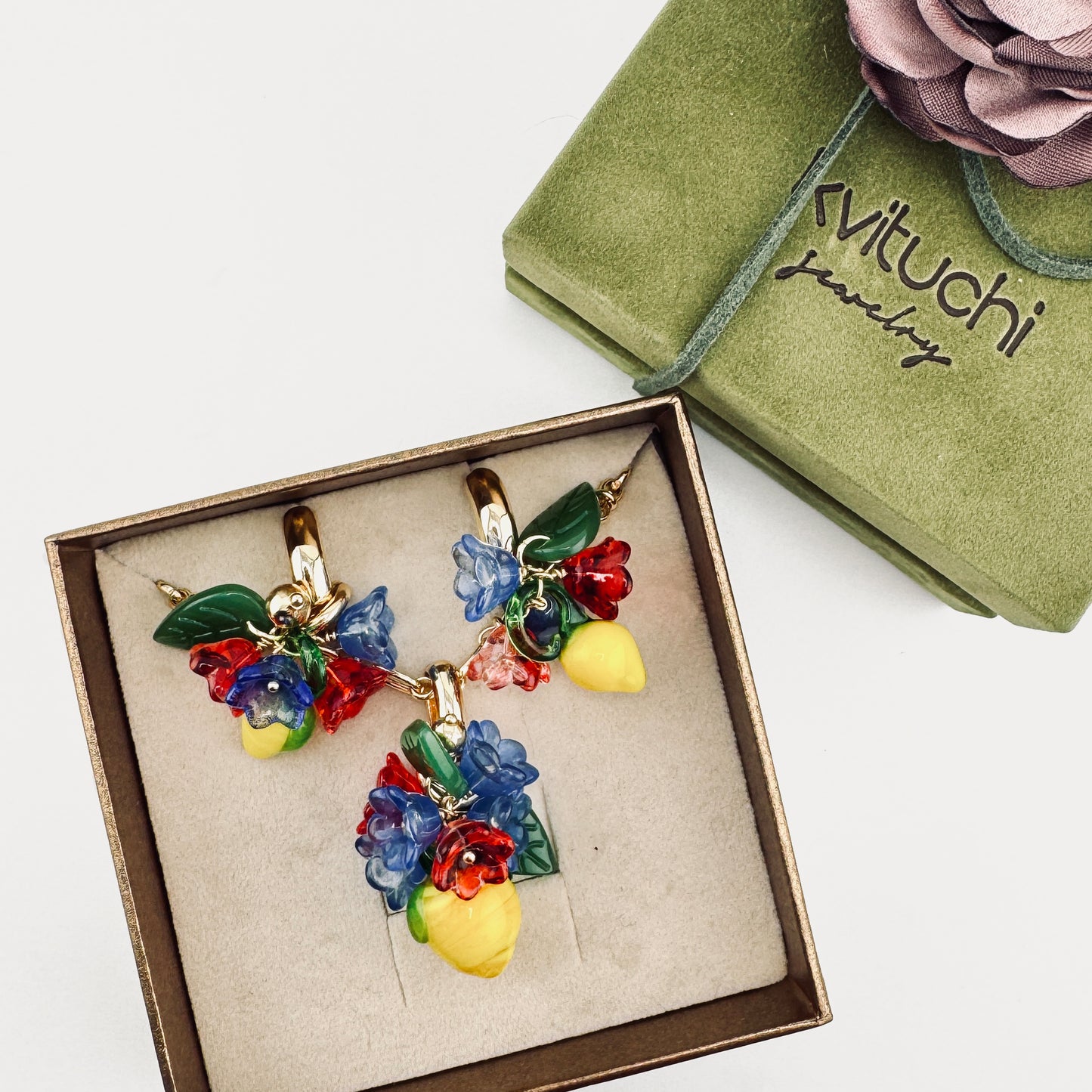 Positano jewelry set with glass lemon and flower pendant necklace and matching earrings in a luxurious khaki suede gift box with gold accents